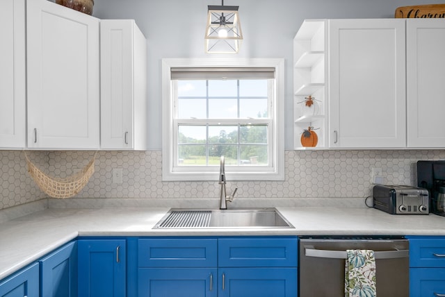 kitchen featuring backsplash, blue cabinets, sink, and stainless steel dishwasher