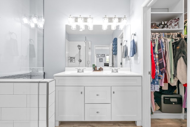 bathroom with vanity, a shower, and wood-type flooring