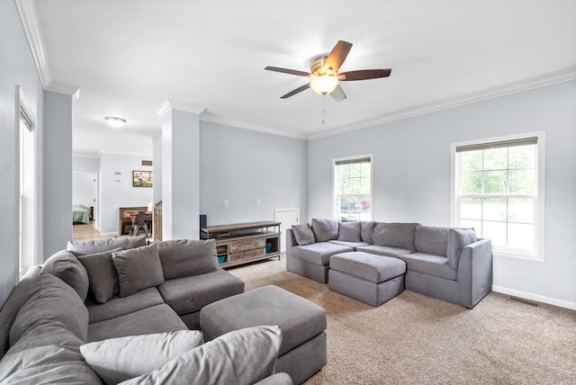 carpeted living room featuring a healthy amount of sunlight, ceiling fan, and ornamental molding