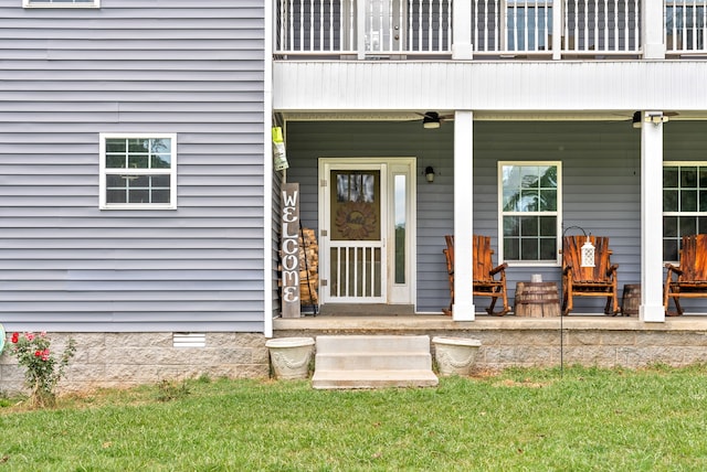 entrance to property with a yard and covered porch