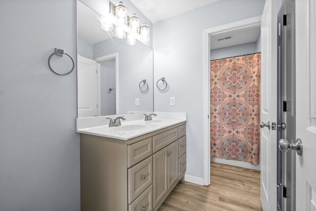 bathroom with vanity, hardwood / wood-style floors, and walk in shower