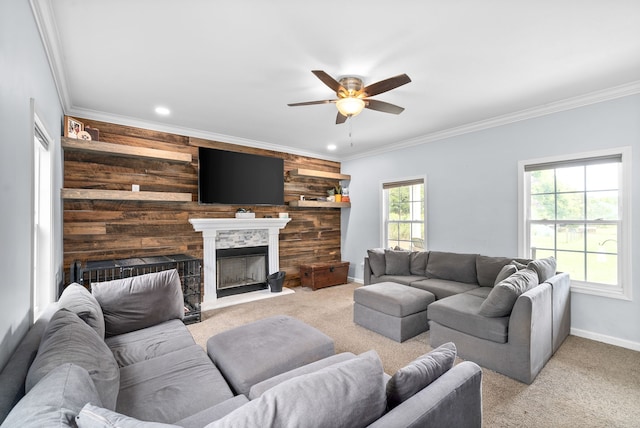 living room featuring ceiling fan, light colored carpet, and crown molding