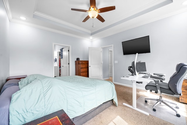 bedroom with ornamental molding, a raised ceiling, ceiling fan, and carpet flooring