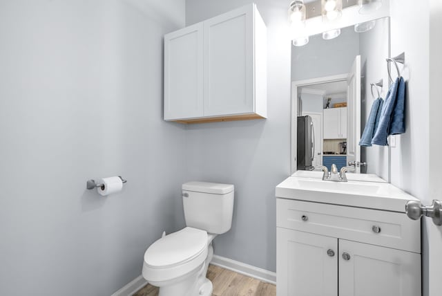 bathroom featuring vanity, toilet, and hardwood / wood-style floors