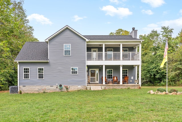 rear view of property featuring a yard, a patio area, and central AC