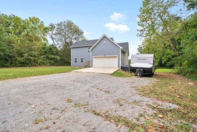 view of front of home with a garage and a front lawn