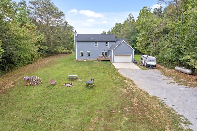 view of front of home with a front yard and an outdoor fire pit