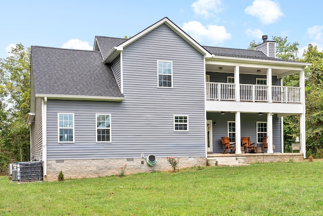 rear view of property featuring a balcony, central AC unit, and a lawn