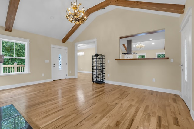 entryway featuring hardwood / wood-style flooring, a chandelier, and vaulted ceiling with beams