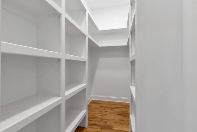 spacious closet featuring hardwood / wood-style floors