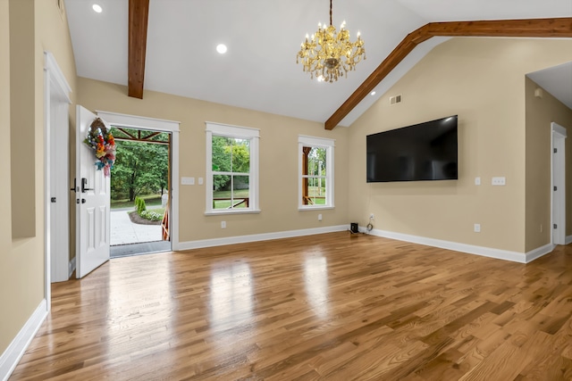 unfurnished living room with lofted ceiling with beams, light hardwood / wood-style flooring, and an inviting chandelier