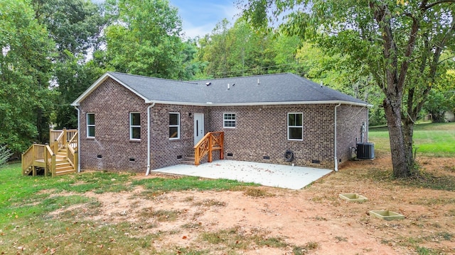 back of house with a lawn, a patio area, and central AC