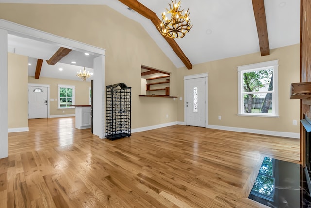 entrance foyer with light hardwood / wood-style flooring, beamed ceiling, high vaulted ceiling, and a chandelier