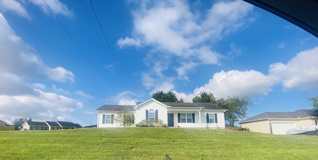 view of front facade with a front yard and a garage