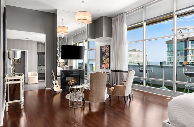 dining space with plenty of natural light, dark hardwood / wood-style floors, and a chandelier