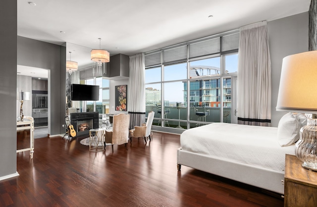 bedroom with dark hardwood / wood-style flooring and ensuite bathroom