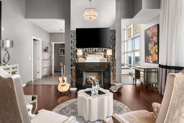 living room with dark hardwood / wood-style floors and a notable chandelier