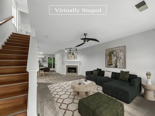 carpeted living room featuring ceiling fan