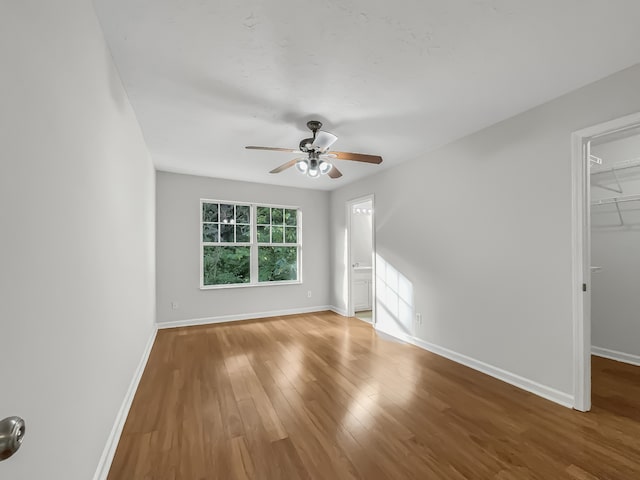 unfurnished room featuring hardwood / wood-style floors and ceiling fan