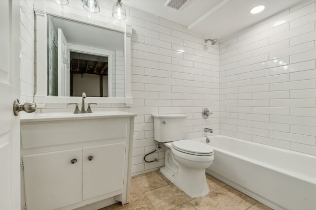 full bathroom featuring tile walls, toilet, washtub / shower combination, and vanity