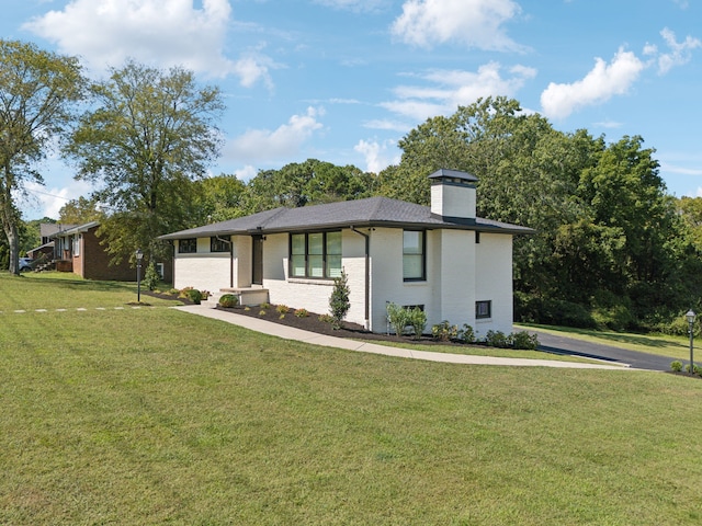 view of front facade with a front lawn and a garage