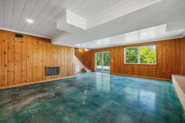 empty room featuring wooden walls and heating unit