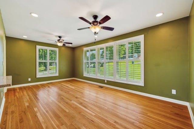 unfurnished room featuring ceiling fan and light hardwood / wood-style floors