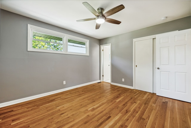 unfurnished bedroom with a closet, ceiling fan, and hardwood / wood-style flooring