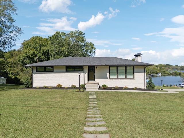 view of front facade with a water view and a front yard