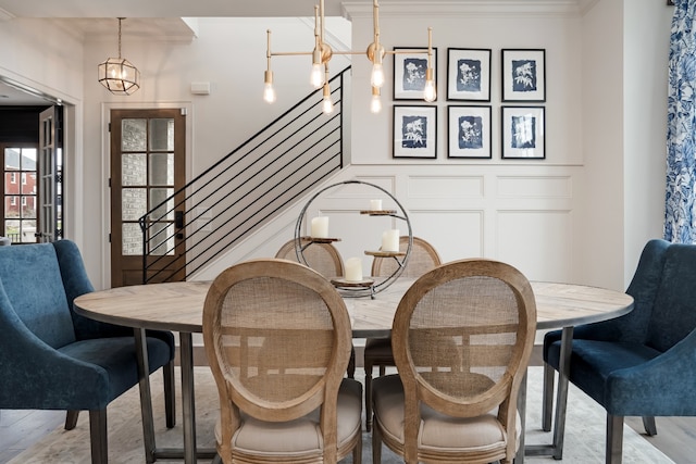 dining room with crown molding, a notable chandelier, and wood-type flooring