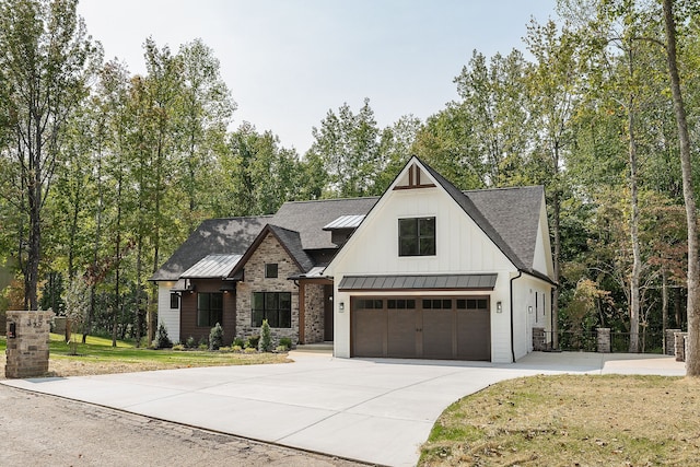 modern farmhouse style home featuring a garage and a front lawn