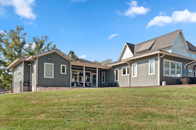 back of property with a lawn and a patio area