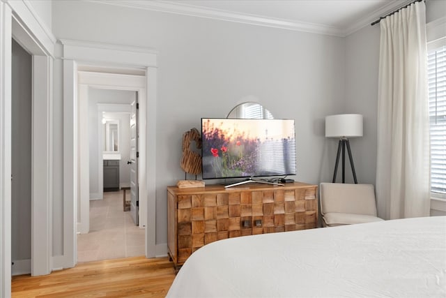 bedroom featuring crown molding and hardwood / wood-style flooring