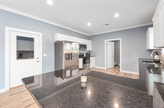 kitchen featuring a sink, visible vents, appliances with stainless steel finishes, and white cabinets