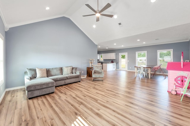 living room featuring light wood-type flooring, baseboards, and high vaulted ceiling