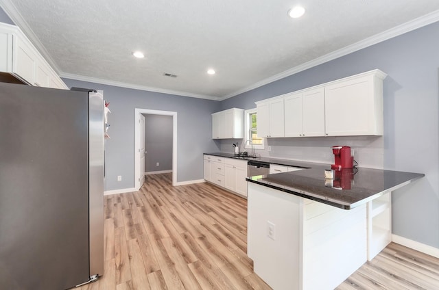 kitchen with white cabinets, light wood finished floors, appliances with stainless steel finishes, and a sink