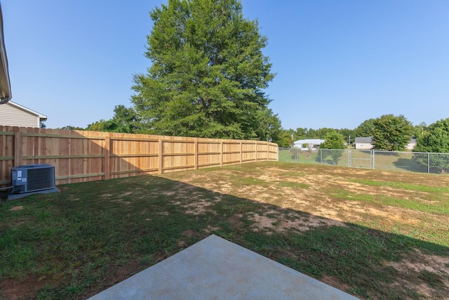 view of yard featuring central AC unit and a fenced backyard