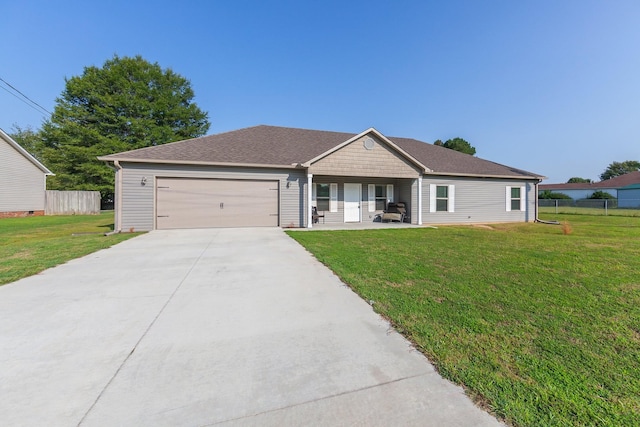 ranch-style house featuring fence, roof with shingles, an attached garage, a front lawn, and concrete driveway