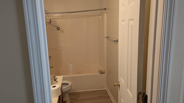full bathroom featuring shower / bath combination, baseboards, toilet, and wood finished floors