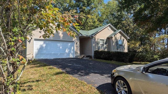 ranch-style home with aphalt driveway and a garage
