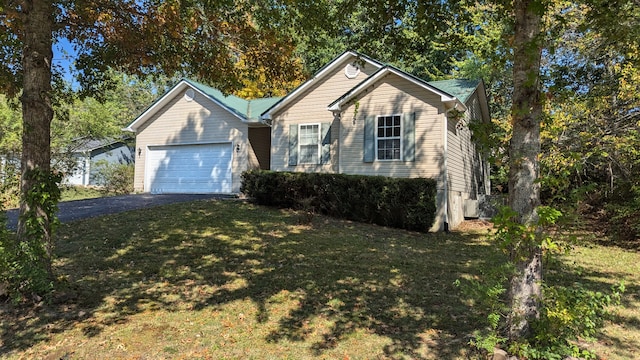 view of front of house with a front lawn and a garage