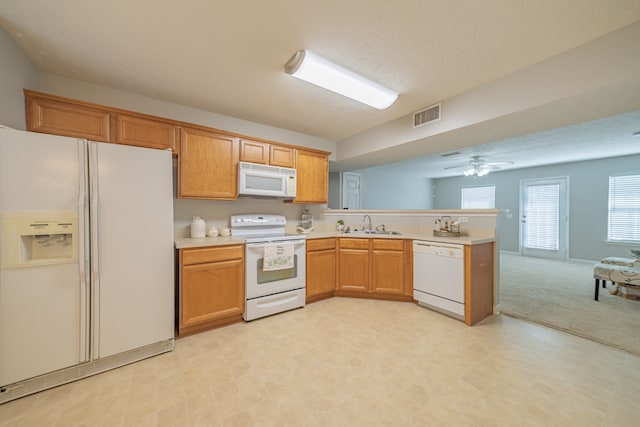 kitchen with light carpet, white appliances, kitchen peninsula, sink, and ceiling fan