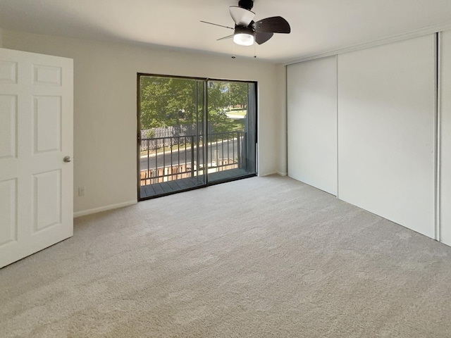 unfurnished bedroom featuring access to outside, carpet, a closet, and ceiling fan