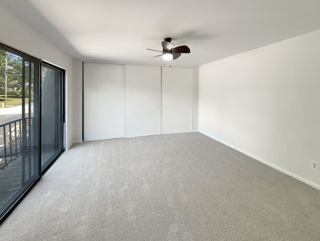 spare room featuring ceiling fan and carpet flooring