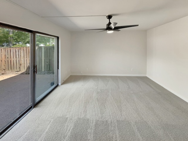 carpeted spare room featuring ceiling fan