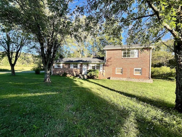 rear view of property with a lawn