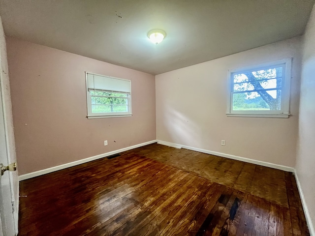 empty room with hardwood / wood-style floors