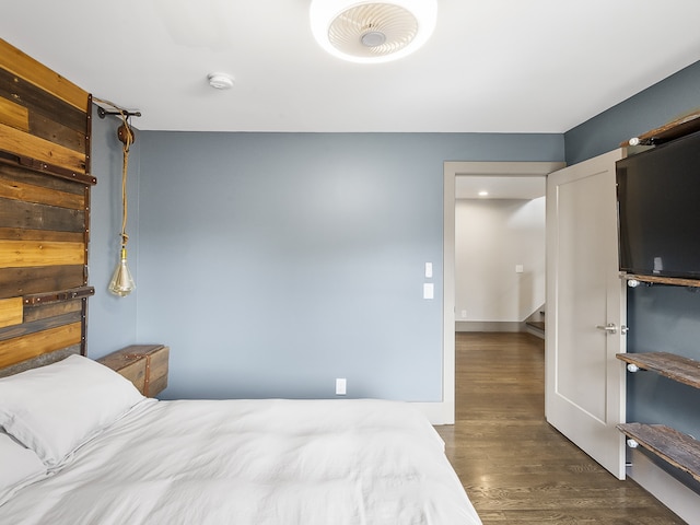 bedroom with dark hardwood / wood-style flooring