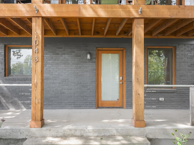 property entrance featuring brick siding