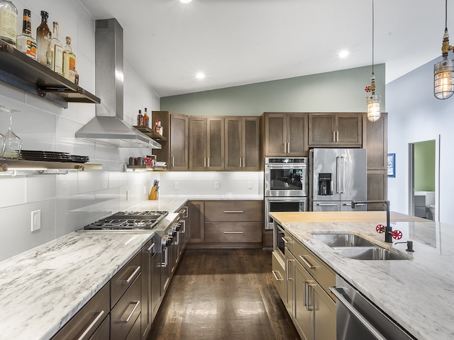 kitchen with stainless steel appliances, vaulted ceiling, sink, dark hardwood / wood-style floors, and wall chimney exhaust hood